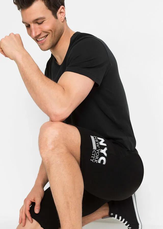 Black regular fit open hem sweat shorts with print